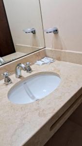 a bathroom counter with a white sink and a mirror at canto del viento in Tilcara +16 photos