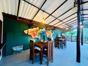 a dining room with a table and chairs at Ceylan Breeze Beach Resort in Tangalle