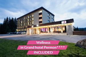 a hotel with a sign in front of a building at Hotel Pieris in Vysoke Tatry - Podbanske