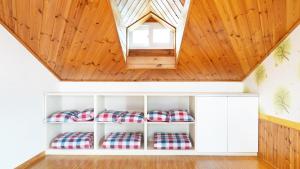 a room with four pillows on shelves under a wooden ceiling at Gangwha Jeongwon Pension in Incheon +11 photos