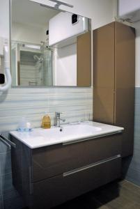 a bathroom with a sink and a mirror at Affittacamere Piazza Castello in Manarola