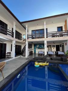 a villa with a swimming pool and a house at Gili Ocean Club - ADULTS ONLY in Gili Trawangan