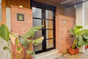 a brick building with a window and some plants at Super Collection O Market Road Ernakulam in Cochin +22 photos