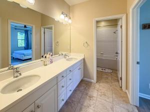 a bathroom with two sinks and a large mirror at #Marbella Lane - Vibrant 4BR Home in Irvine in Irvine +10 photos