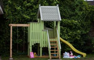 una casa de juegos con una escalera y un tobogán en Marbella en Ventspils