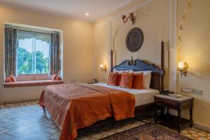 a bedroom with a large bed and a window at Rajasthan Palace - A Heritage Boutique Hotel in Jaipur in Jaipur +261 photos
