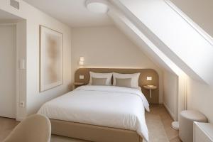 une chambre avec un lit blanc dans un grenier dans l'établissement VISIONAPARTMENTS Leonhardstrasse - contactless check-in, à Zurich 14 autres photos