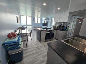 a kitchen with a sink and a counter top at 1 bdrm Island Escape with Ocean Views & Family Comfort Condominio Isleta marina in Fajardo