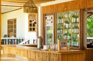a bar in a restaurant with a counter at Beach Front Cabana 1, Puraran Surf Resort in Sampong