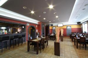 a restaurant with tables and chairs and a bar at Penzión Pagy in Višňové