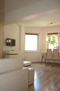 a living room with a white couch and a table at Apartament Light & Bright in Międzyzdroje