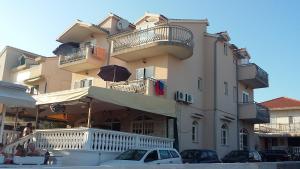 a building with cars parked in front of it at Apartments Marina View in Vodice