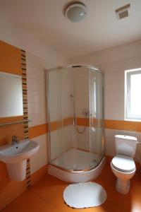 a bathroom with a shower and a toilet and a sink at Penzión Pagy in Višňové +8 photos