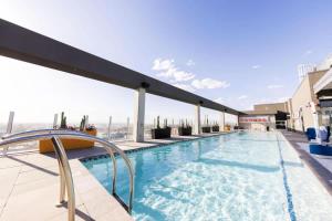 a swimming pool on the roof of a building at Boulevard Stays Highrise STU Sky Pool Parking Gym 22 in Phoenix