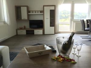 a table with a bottle of wine and two wine glasses at Glaneggerhof in Glanegg