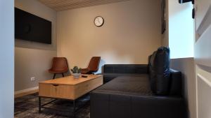 a living room with a couch and a table at NesttunPearl in Bergen