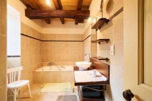 a bathroom with a sink and a bath tub at Maison de Ferme in Montagrier