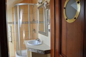 a bathroom with a sink and a mirror at Central Łeba Suites in Łeba