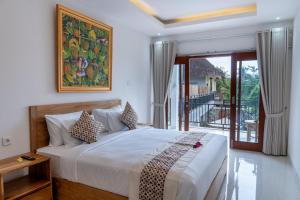 Ένα ή περισσότερα κρεβάτια σε δωμάτιο στο Graha Dwarkavati Ubud +55 φωτογραφίες