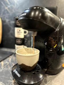 a black mixer sitting on a counter with a bowl at Ciné-Ponot in Le Puy en Velay +5 photos