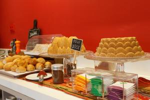 a buffet with several different types of cakes and pastries at Portofino Hotel in Teresina