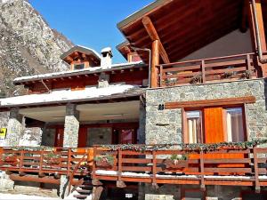 a house with snow on the roof of it at Alpine Bliss A Cosy Retreat in Antey-Saint-André