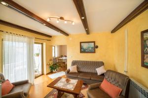 a living room with a couch and a table at Apartment Anica in Rab
