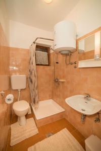 a bathroom with a toilet and a sink at Apartment Anica in Rab