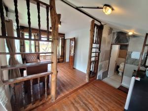 an open hallway with wooden floors and wooden stairs at The Seasons At Pai in Pai