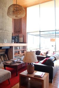 a living room with a couch and a table at Hotel Casa Panguipulli in Panguipulli