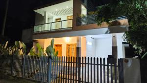 a house with a fence in front of it at Yatra Homestay in Trivandrum