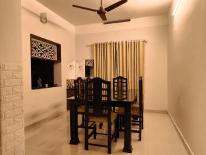 a dining room with a table and chairs at Yatra Homestay in Trivandrum