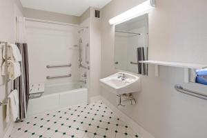 a white bathroom with a sink and a shower at Travelodge by Wyndham Phoenix North in Phoenix +21 photos
