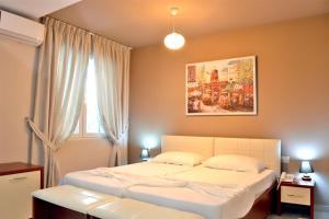 Postel nebo postele na pokoji v ubytování Vila Ada Hotel