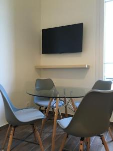 a conference room with a table and chairs and a television at Palais Sapho Residence in Nice