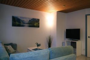 a living room with a couch and a flat screen tv at Apartment Goldey in Unterseen