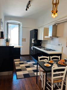 a kitchen with a table and chairs in a room at La Bora Roiana in Trieste