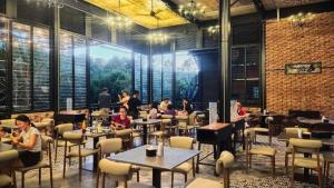 a group of people sitting at tables in a restaurant at The Lumpang Resort in Kerling