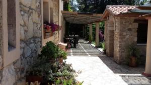 an outdoor patio with a table and a brick building at Agriturismo Casal Taccone in Tarquinia