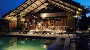 a resort with a pool and tables and chairs at The Lumpang Resort in Kerling