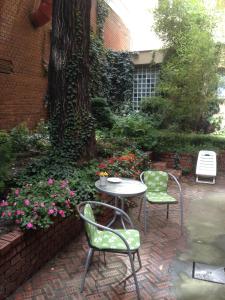 a patio with a table and two chairs and a tree at Apartment Art Deco Budapest in Budapest