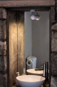a bathroom with a sink and a toilet and a mirror at Casa do Simão in Nordeste