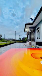 a large pool in front of a house at Adyan Homestay Terengganu in Bukit Payong