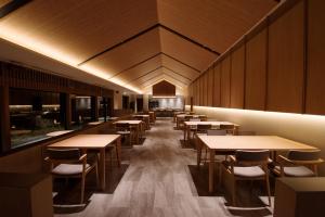 a row of tables and chairs in a restaurant at 山人 Oga in Oga
