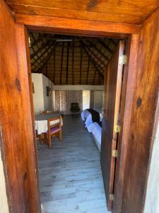 an open door to a room with two beds at Pavlovna Comfy 4 Cottage in Himeville