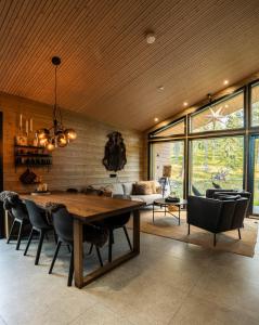 a dining room with a wooden table and chairs at Villa Golden Hill Ylläs, Luxury holiday cabin in Lapland in Äkäslompolo