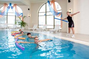 a man playing frisbee in a swimming pool at Hotel Batashev in Vyksa