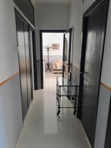 a hallway with two doors and a glass table at The bathers' Home in Nettuno