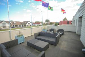 a balcony with chairs and flags on a building at Abbots Hamilton – Hotel and Conference Centre in Hamilton
