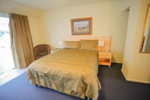 a hotel room with a bed and a window at Abbots Hamilton – Hotel and Conference Centre in Hamilton